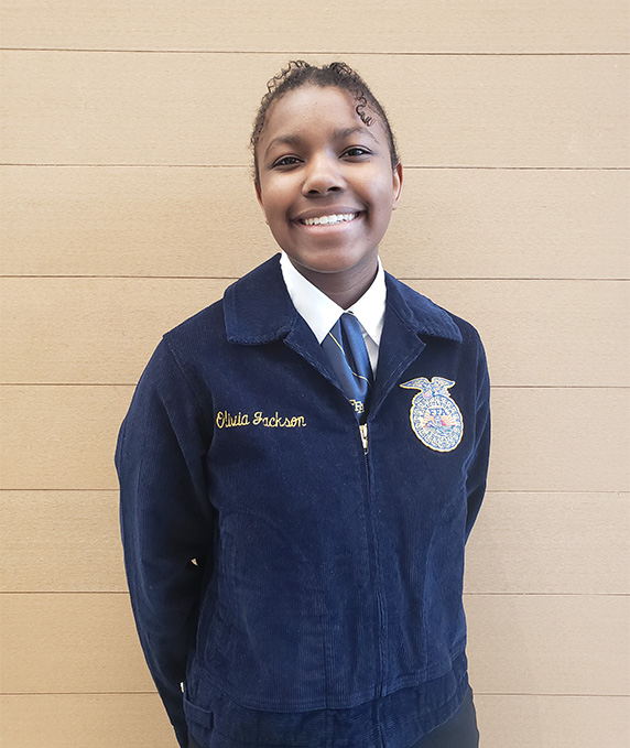 FFA member in full uniform smiles for photo.